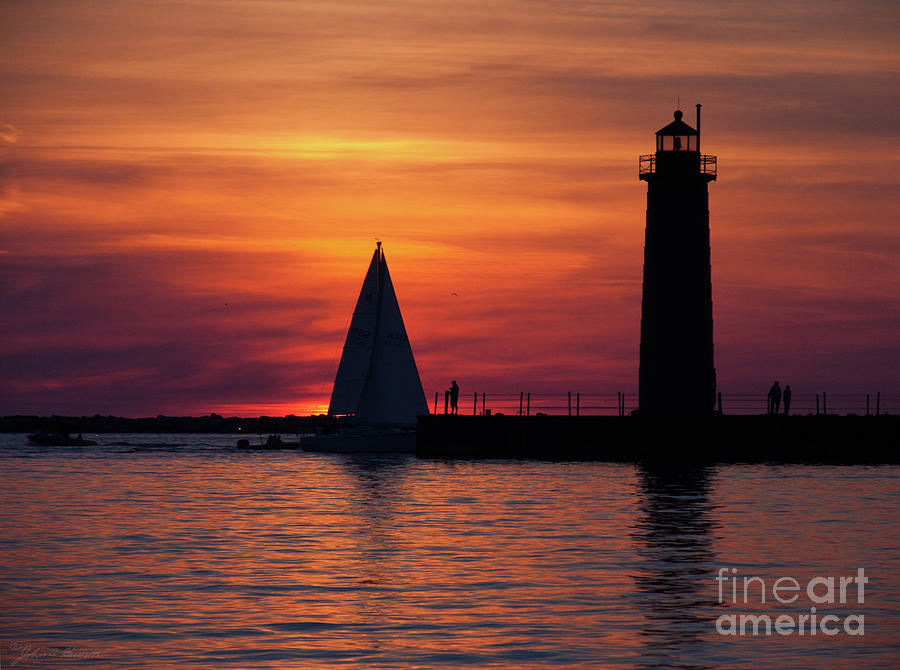 Boats entering the Channel at the Muskegon Lighthouse Photograph by John Harmon