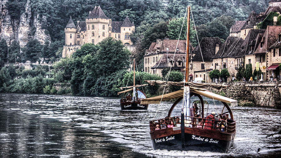 Boats sailing the Dordogne river in La Roque Gageac Photograph by Weston Westmoreland