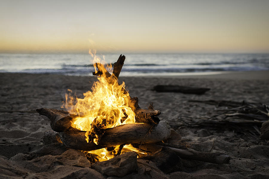 Bonfire burning on beach Photograph by Lindsay Upson
