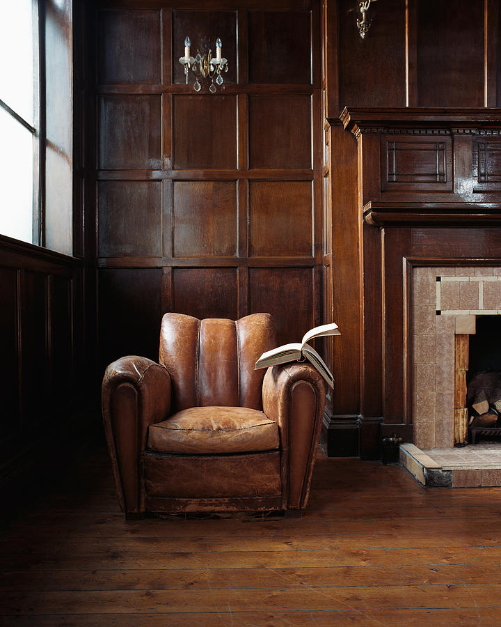 Book on a leather armchair Photograph by Image Source
