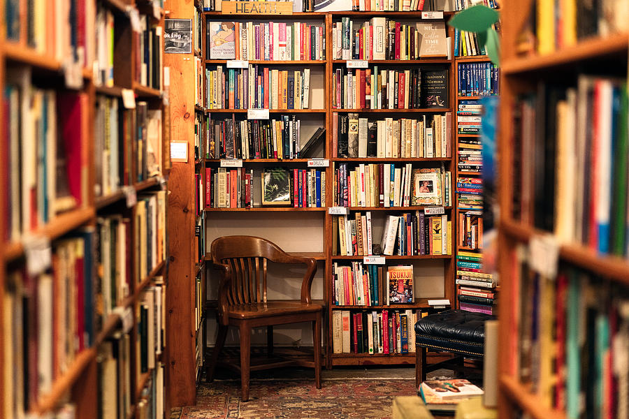 Books on display in the corner of a second hand bookstore Photograph by Georgeclerk