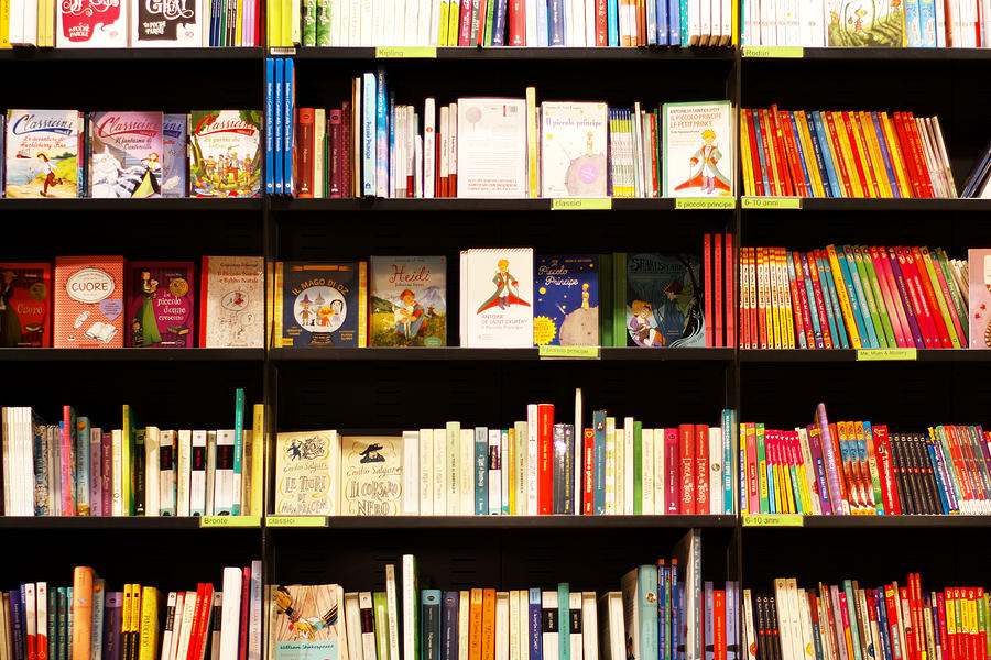 Books on shelves in bookstore Photograph by Maurizio Siani