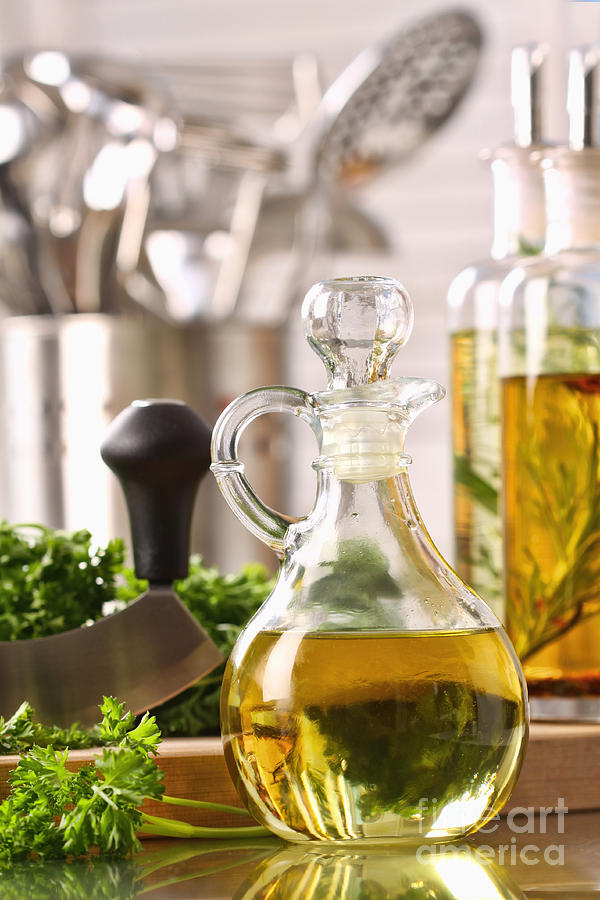Bottle of olive oil and fresh parsley  Photograph by Sandra Cunningham