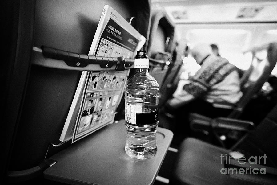 Cabin Photograph - Bottle Of Water On Tray Table Interior Of Jet2 Aircraft Passenger Cabin In Flight Europe by Joe Fox