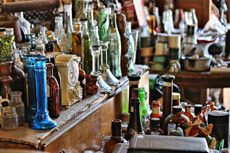 Bottles in the Old Stuff Shop Photograph by Lynn Jordan
