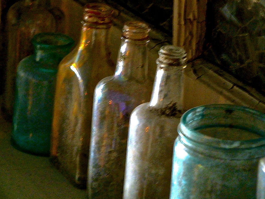 Bottles on shelf Photograph by Lesley McCormack