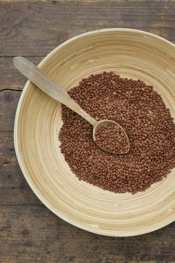 Bowl Of Lentils With Wooden Spoon On Photograph by Westend61