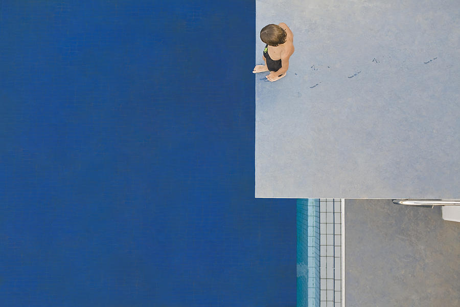 Boy (6-7) standing on diving board, overhead view Photograph by Photo and Co