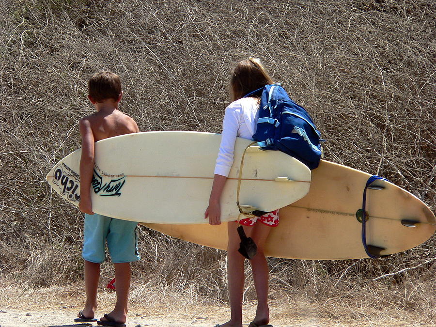 Boy and Girl Carrying Surfboards Photograph by Jeff Lowe