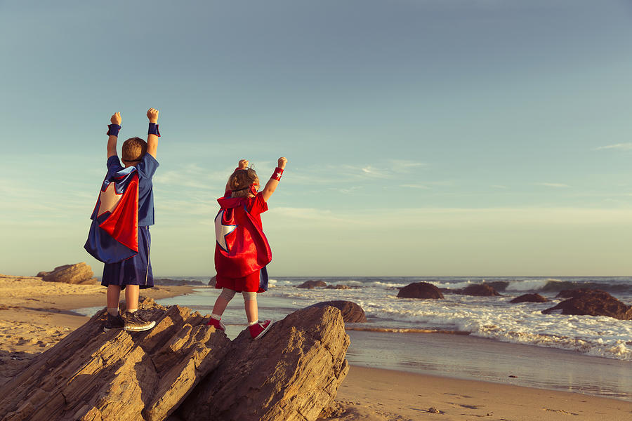 Boy and Girl dressed as Superheroes on California Beach Photograph by RichVintage