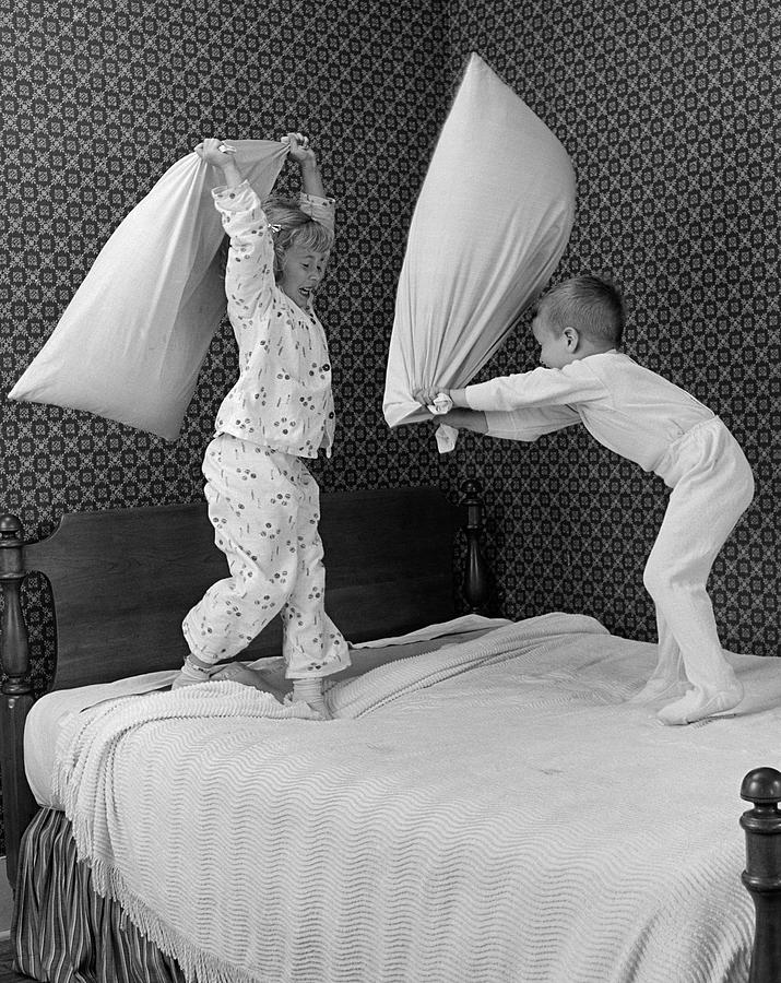 Boy And Girl Having A Pillow Fight Photograph by B. Taylor/ClassicStock