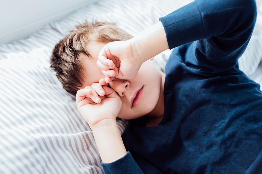 Boy awakening from a deep sleep Photograph by Click&Boo