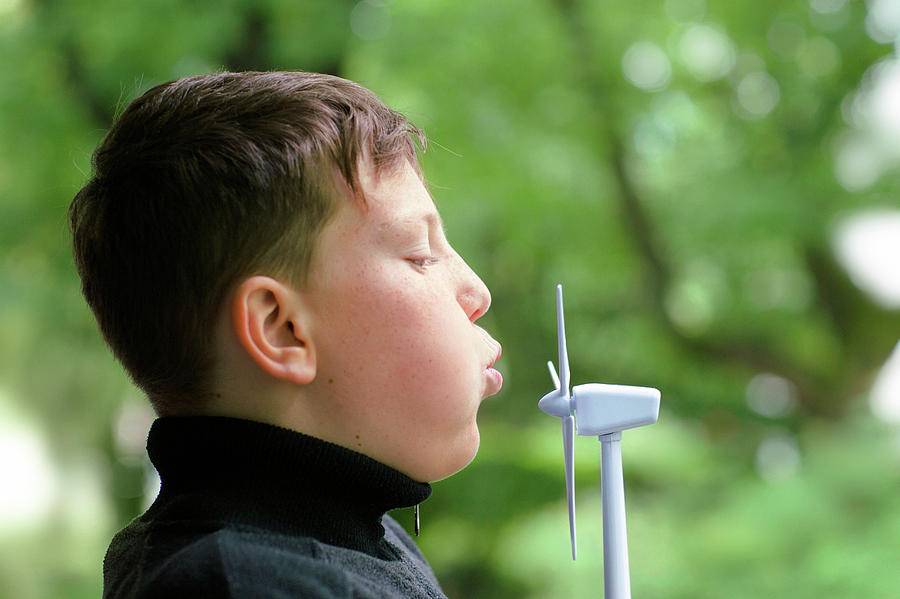 Boy Blowing Miniature Wind Turbine Photograph by Gombert, Sigrid