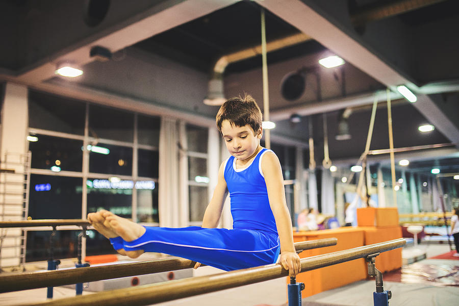 Boy exercising on parallel bars. Photograph by M_a_y_a