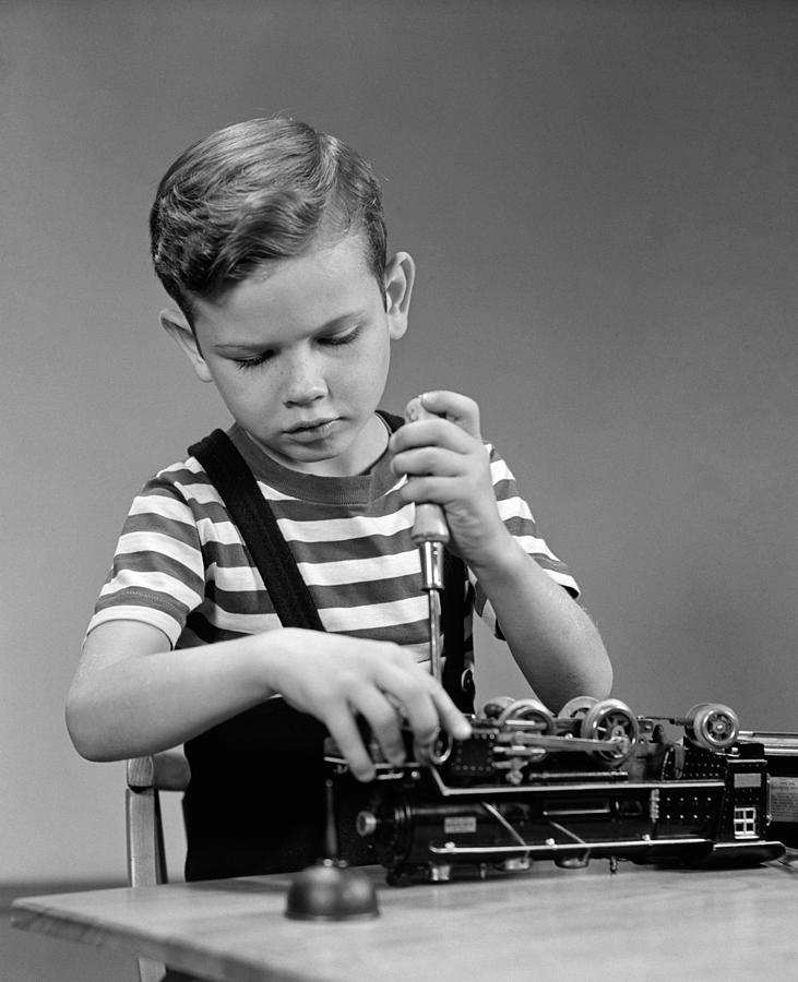 Boy Fixing Toy Train, C.1930-40s Photograph by H. Armstrong Roberts/ClassicStock