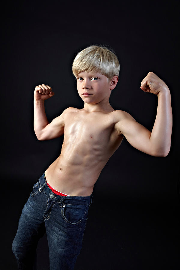 Boy flexing muscles Photograph by Image Source