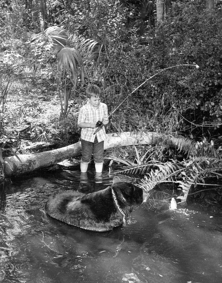 Vintage Photograph - Boy has a unique fishing partner by Retro Images Archive