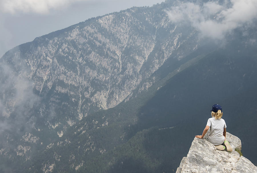 Boy  hiker looks off from high ridge crest, Mount Olympus, home of the gods of ancient Greece Photograph by Paul Biris