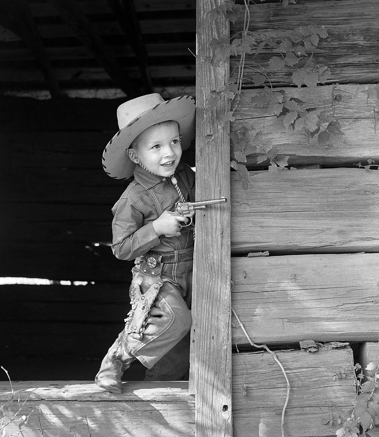 Boy In Cowboy Outfit With Toy Gun Photograph by B. Taylor/ClassicStock