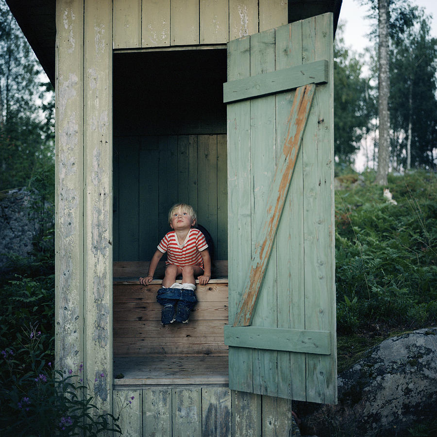 Boy in outhouse Photograph by Johan Willner