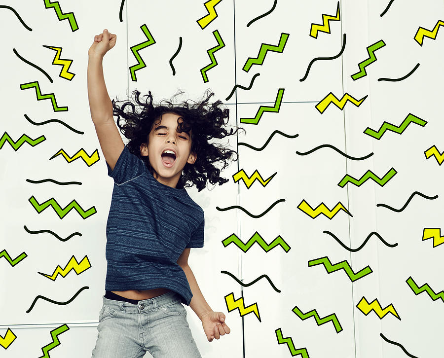 Boy jumping in the air with graphic symbols Photograph by Flashpop