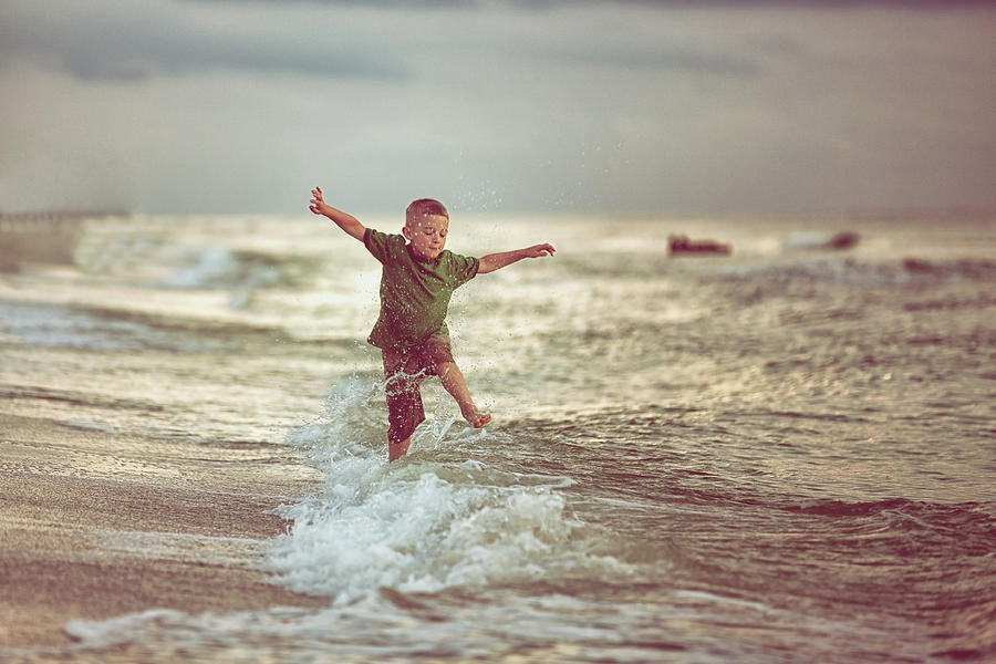 Boy Jumping Over Waves Photograph by Rebecca Nelson