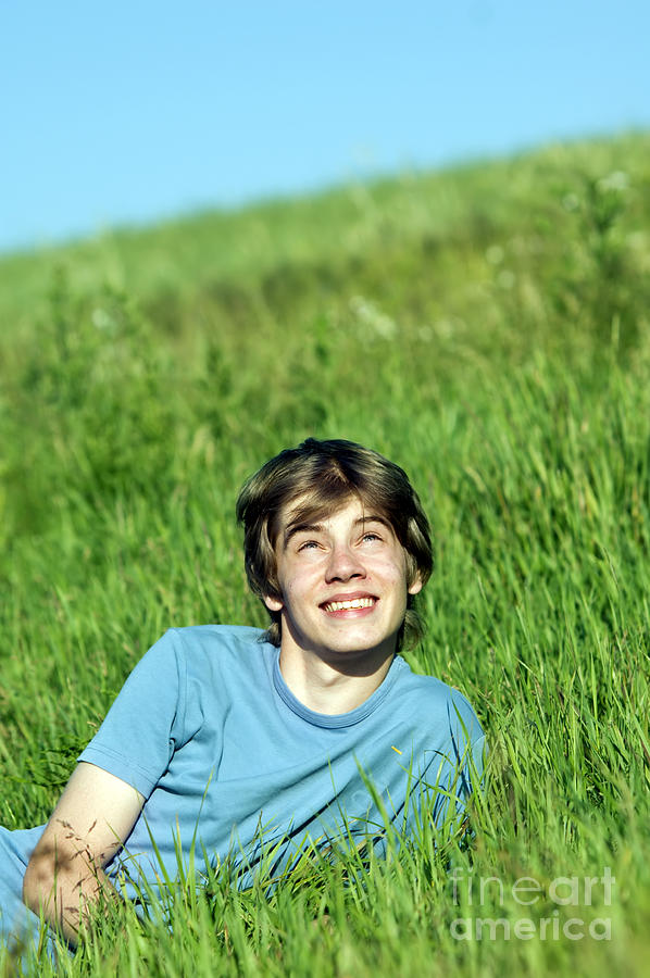 Boy lying on the fresh green grass Photograph by Michal Bednarek