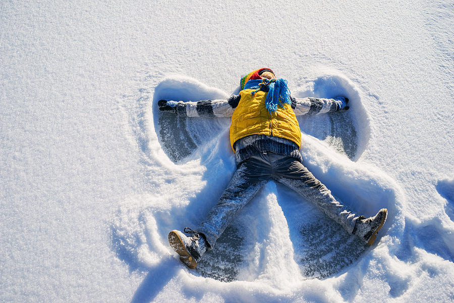 Boy making a snow angel Photograph by Elizabethsalleebauer