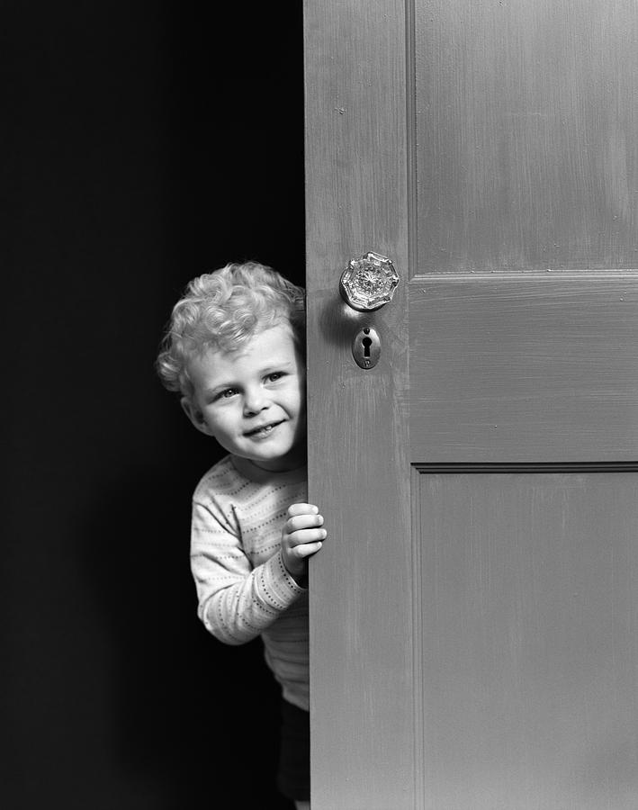 Boy Peeking Around Door, C.1940s Photograph by H. Armstrong Roberts/ClassicStock