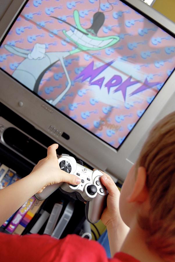 Boy Playing A Video Game Photograph by Aj Photo/science Photo Library