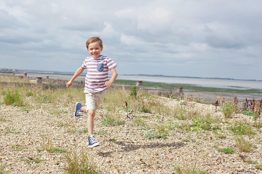Beach Photograph - Boy Running On The Beach by Ian Hooton