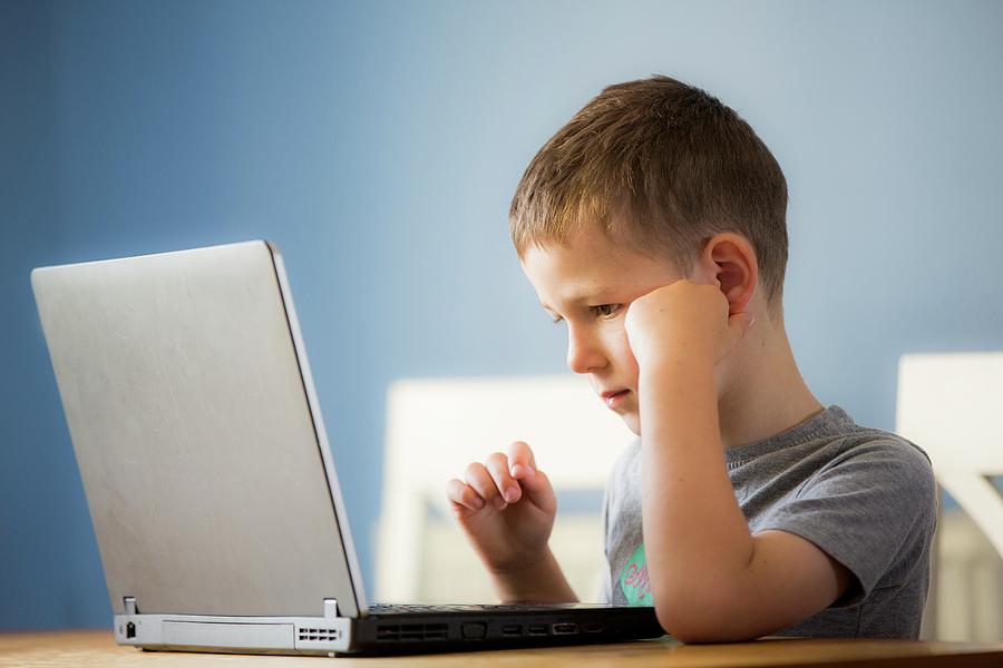 Boy Using Laptop Photograph by Samuel Ashfield