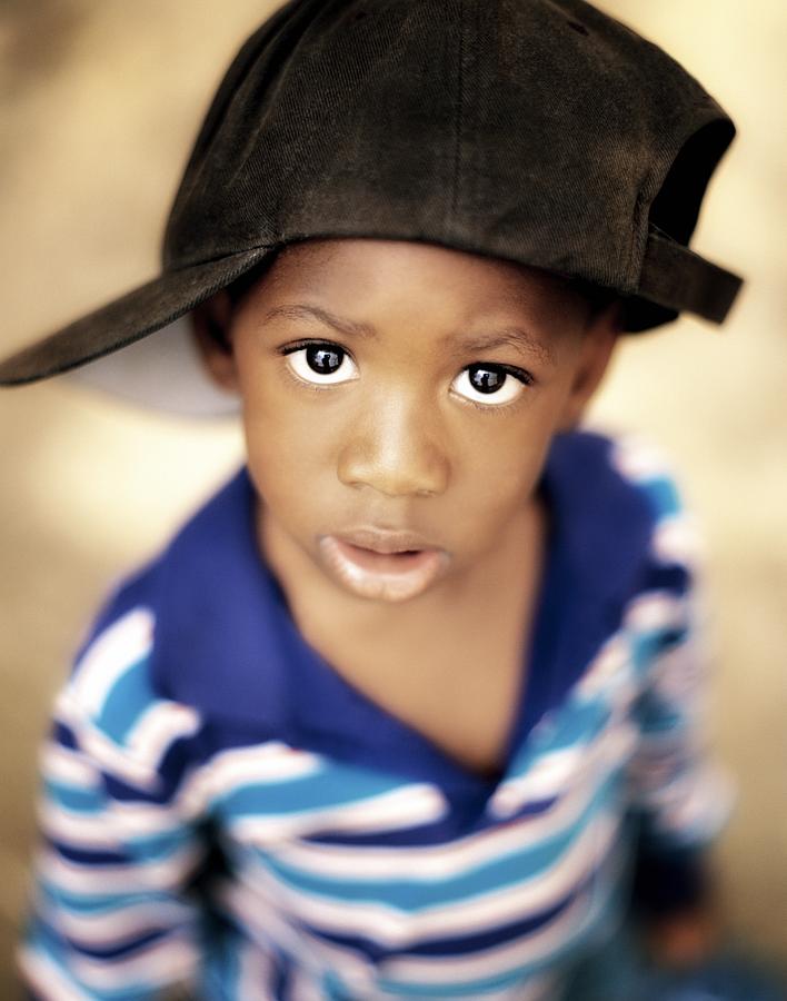 Hat Photograph - Boy Wearing Over Sized Hat Sideways by Ron Nickel