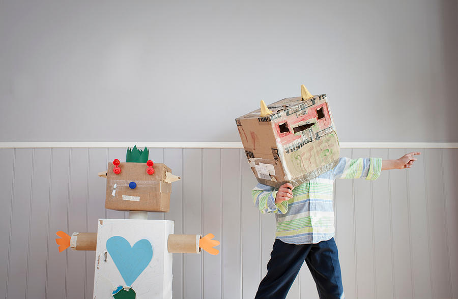 Boy with box covering head and homemade toy robot Photograph by Ian Nolan