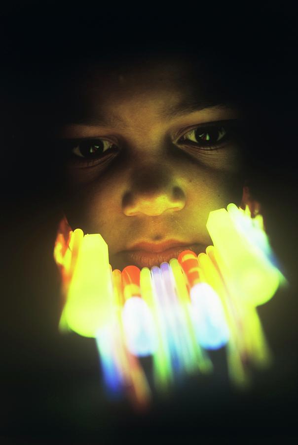 Boys Face Lit By Glow Sticks Photograph by David Hay Jones/science Photo Library