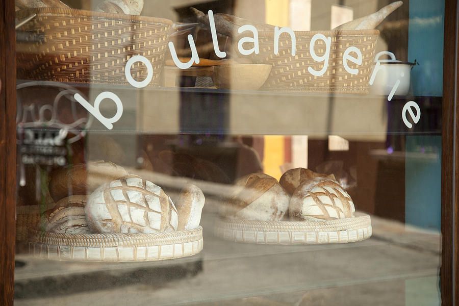 Breads are displayed ad seen through the window of a Mexican bakery Photograph by Timothy Hearsum