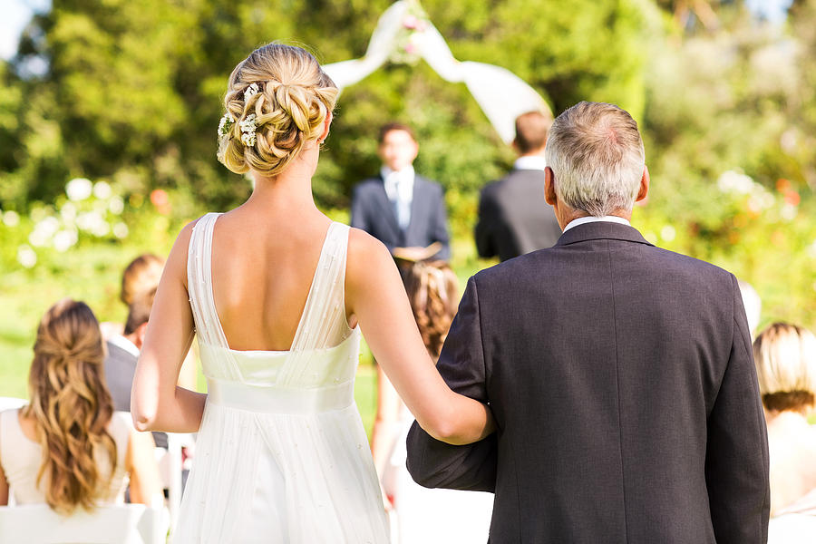 Bride And Father Walking Down The Aisle During Outdoor Wedding Photograph by Neustockimages