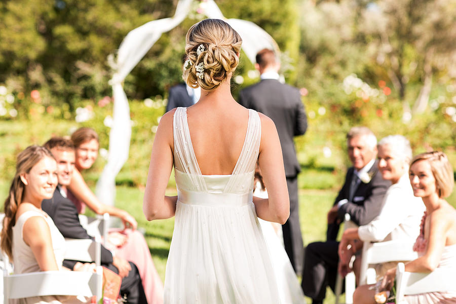 Bride Walking Down The Aisle During Wedding Ceremony Photograph by Neustockimages