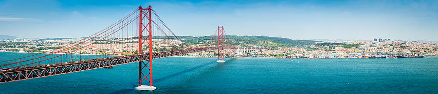 Bridge across blue bay to city beyond Lisbon panorama Portugal Photograph by fotoVoyager