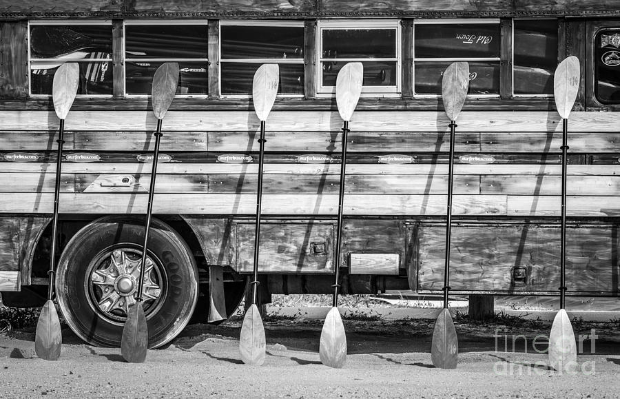 Black And White Photograph - Bright Colored Paddles and Vintage Woodie Surf Bus - Florida - Black and White by Ian Monk