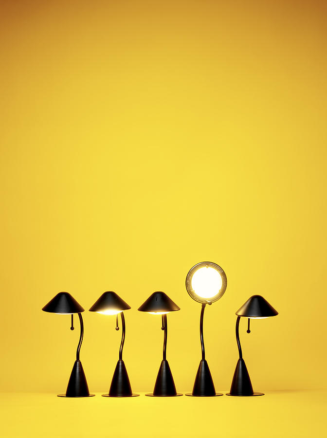 Bright Idea, Five desk lamps against yellow Photograph by Burwellphotography