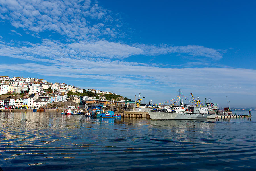 Brixham harbour Devon with boats moored on a calm summer day with blue ...