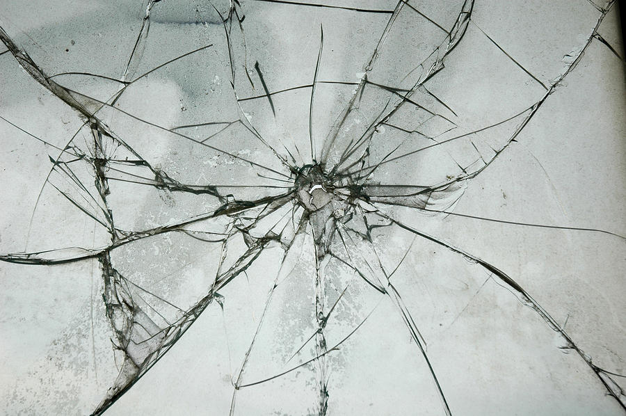 Broken Glass Window Bullet Shooting impact hole cracks Photograph by JoenStock