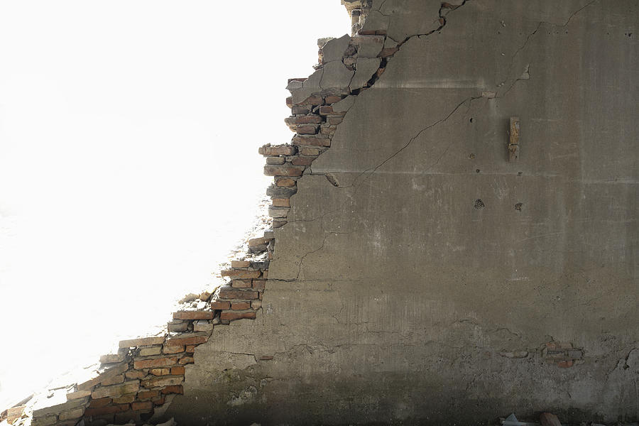 Broken grey wall with bricks,on white background Photograph by Yaorusheng