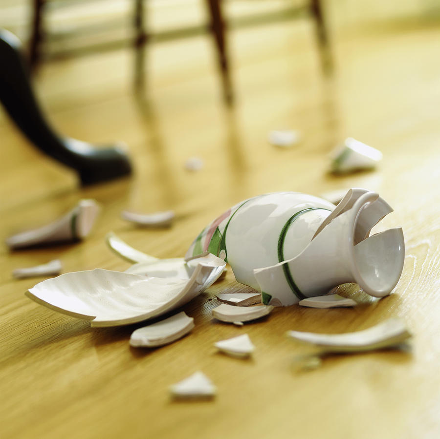 Broken Vase on a Wooden Floor Photograph by Flying Colours Ltd