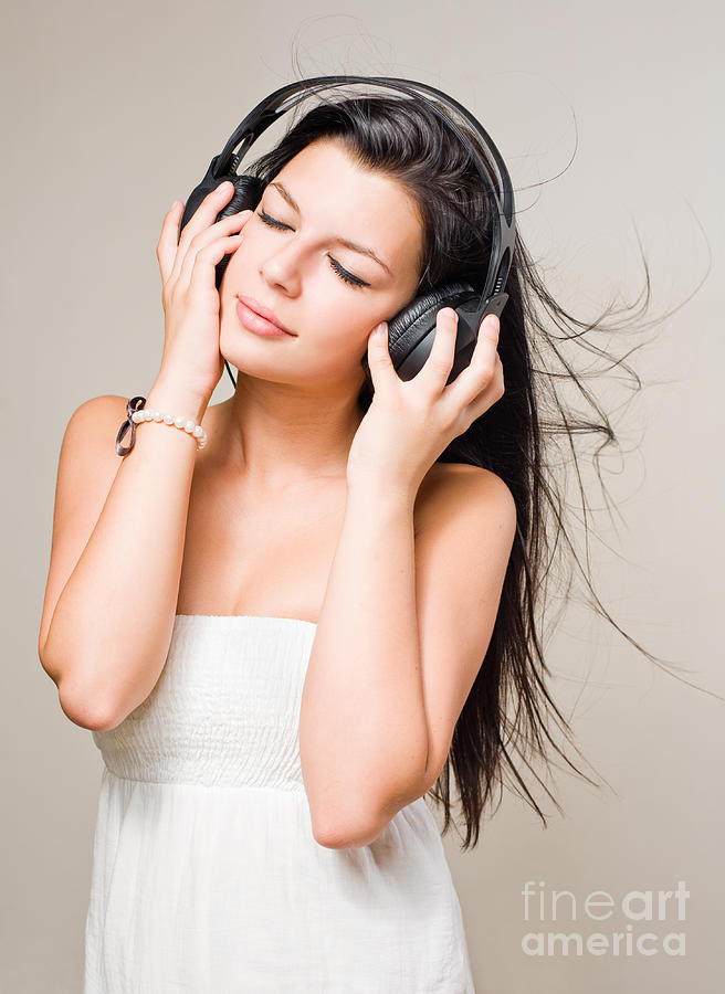 Music Photograph - Brunette immersed in music wearing headphones. by Alstair Thane