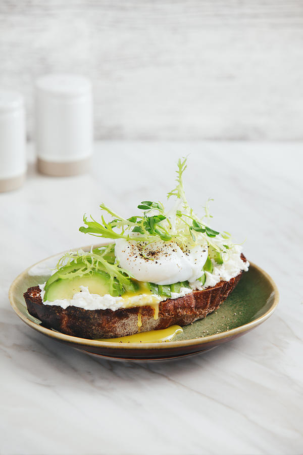 Bruschetta with avocado, ricotta and poached egg Photograph by Eugene Mymrin