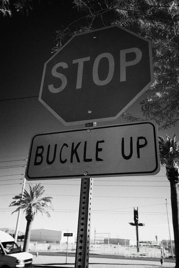 Sign Photograph - buckle up sign below stop sign in Las Vegas Nevada USA by Joe Fox