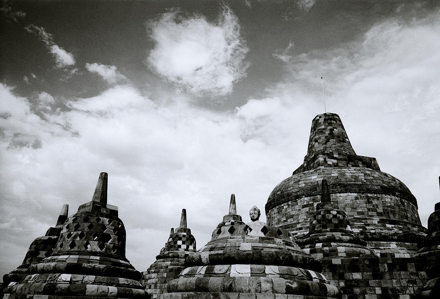 Buddha And The Stupas Of Borobudur Photograph by Shaun Higson