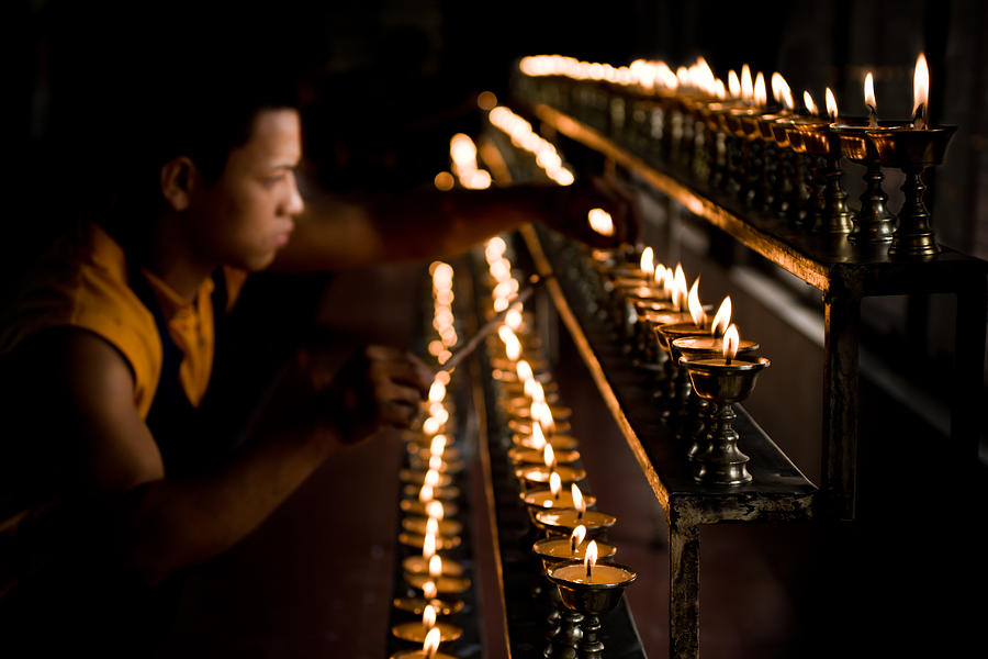 Buddhist Monk Lighting Lamps Photograph by Nila Newsom